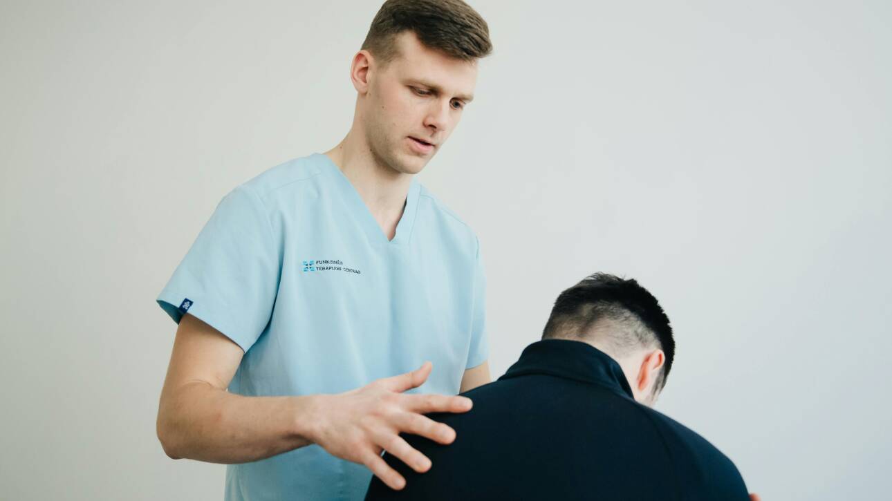 Massage therapist reassuring his client