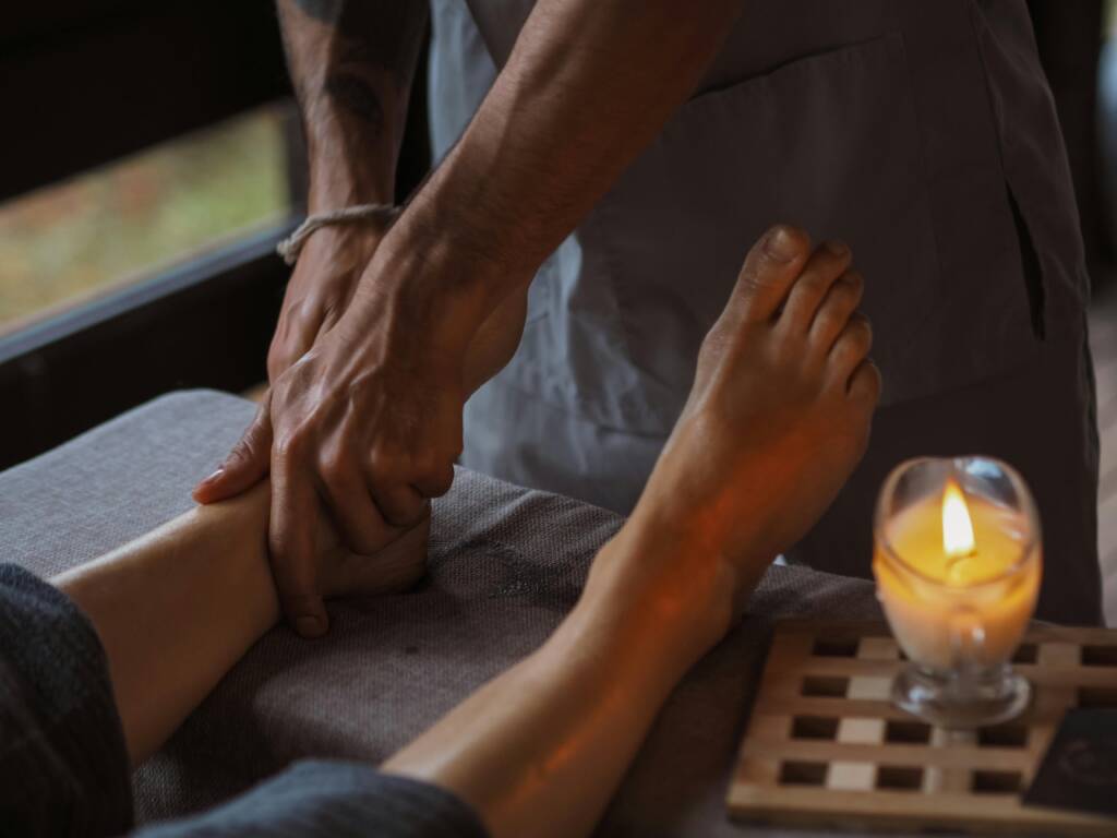 Foot massage with a lit candle