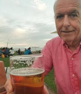 Male companion and escort with a pint