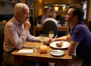 Male companion and escort having dinner