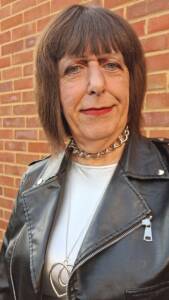 Feminine Companion and Escort wearing a leather jacket